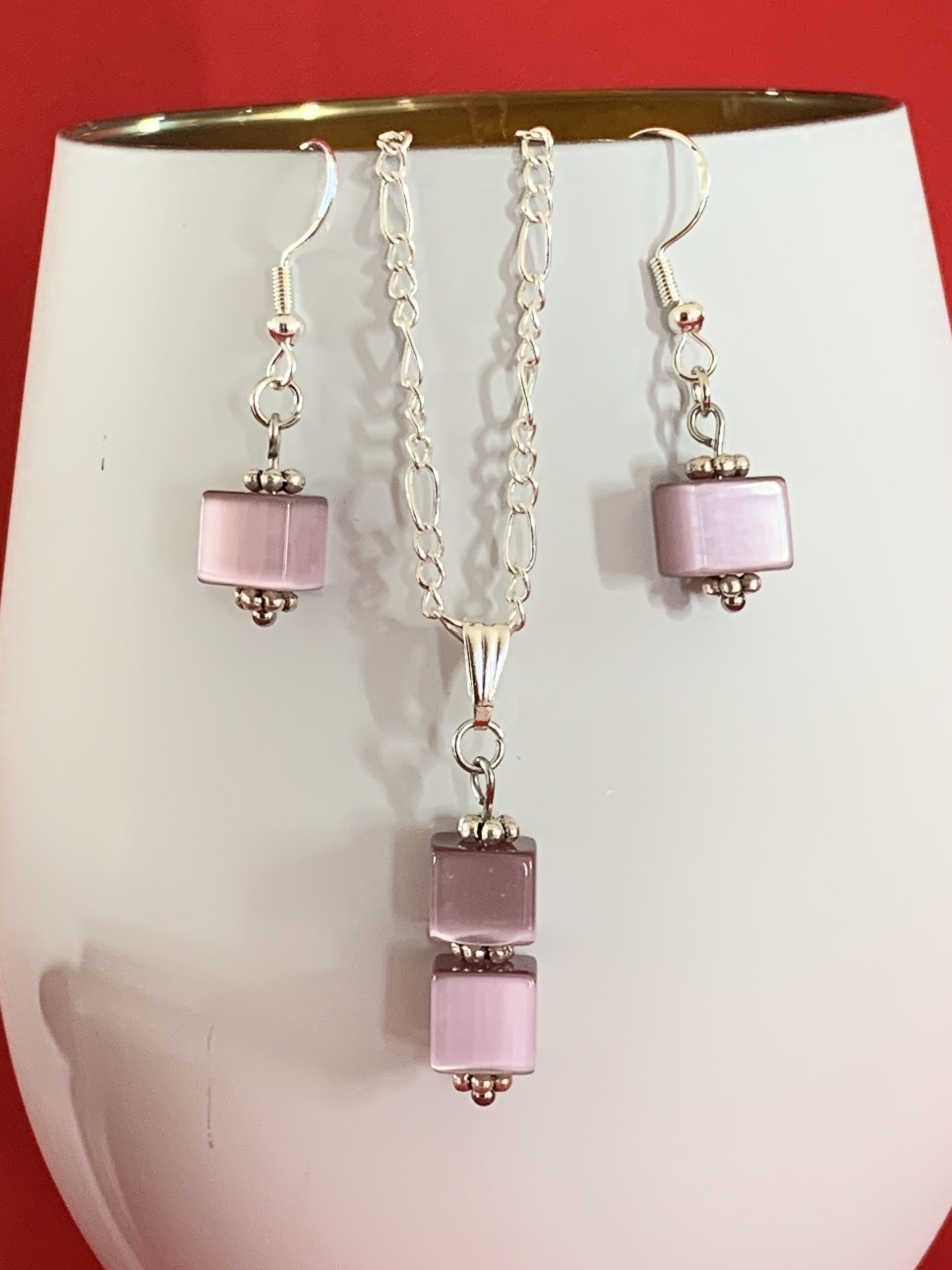 Sterling silver earrings and necklace set with purple squares inside a message in a bottle