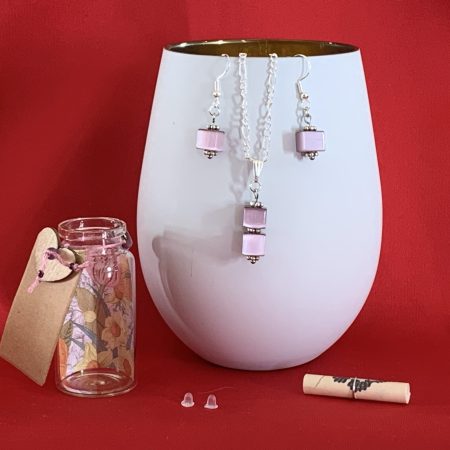 Sterling silver earrings and necklace set with purple squares inside a message in a bottle