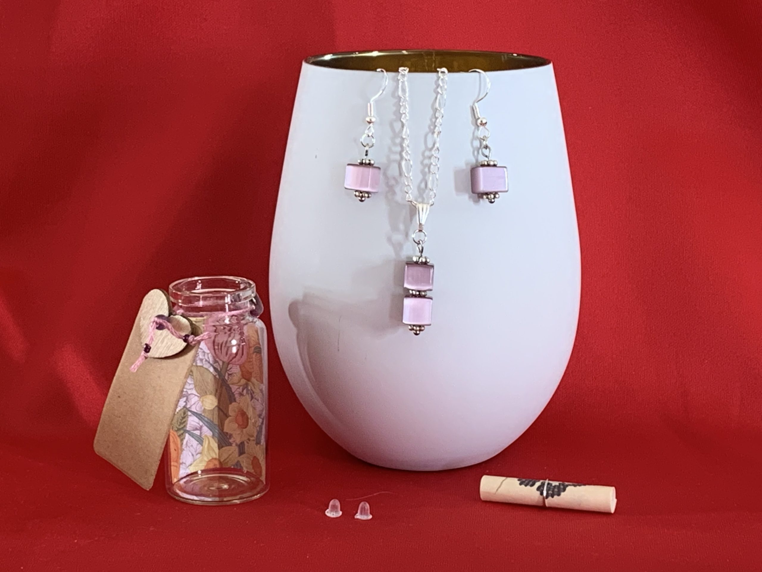 Sterling silver earrings and necklace set with purple squares inside a message in a bottle