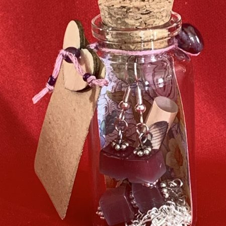 Sterling silver earrings and necklace set with purple squares inside a message in a bottle