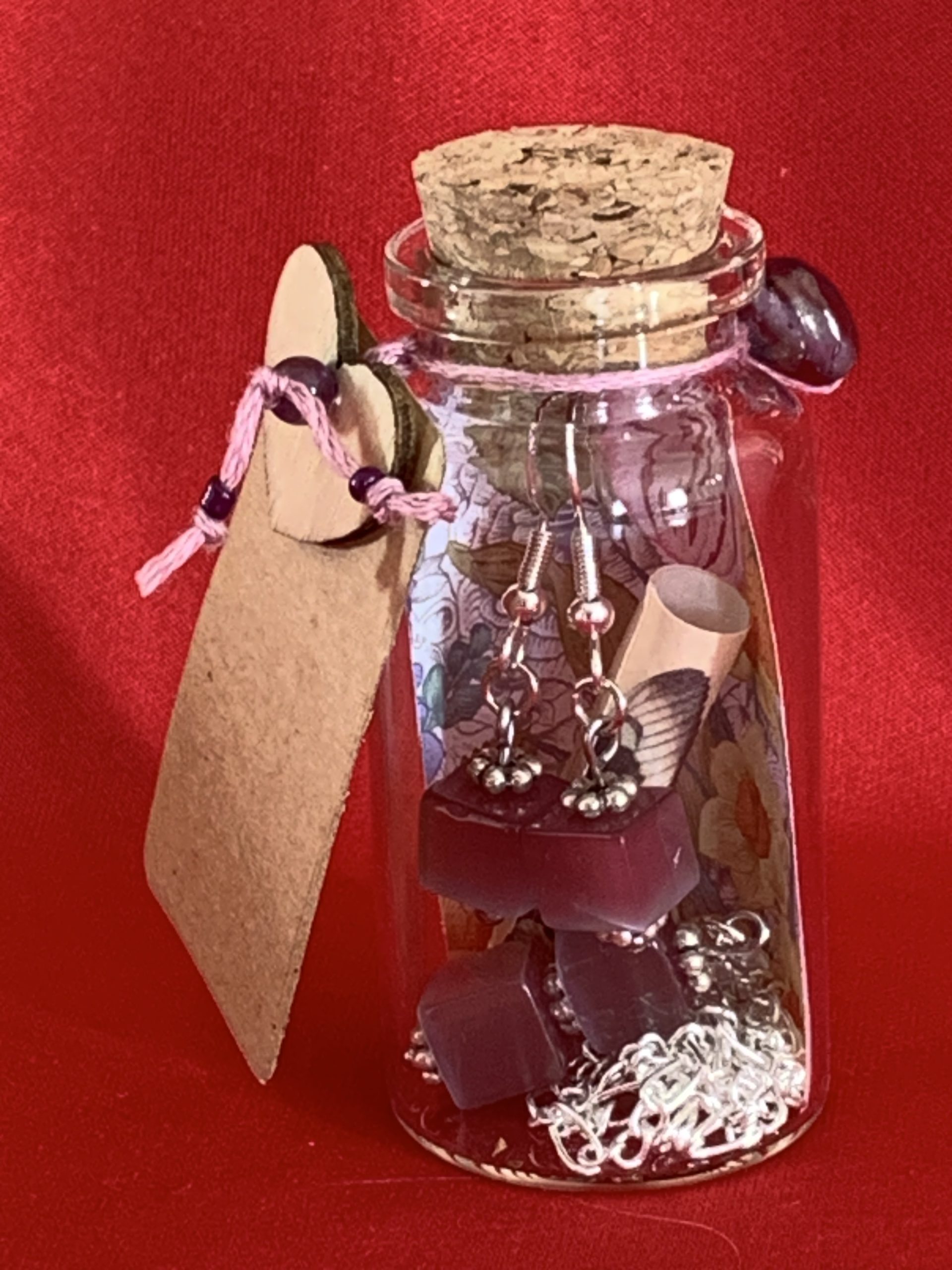 Sterling silver earrings and necklace set with purple squares inside a message in a bottle