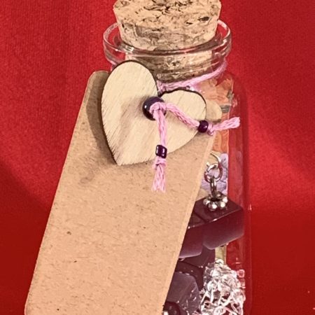 Sterling silver earrings and necklace set with purple squares inside a message in a bottle