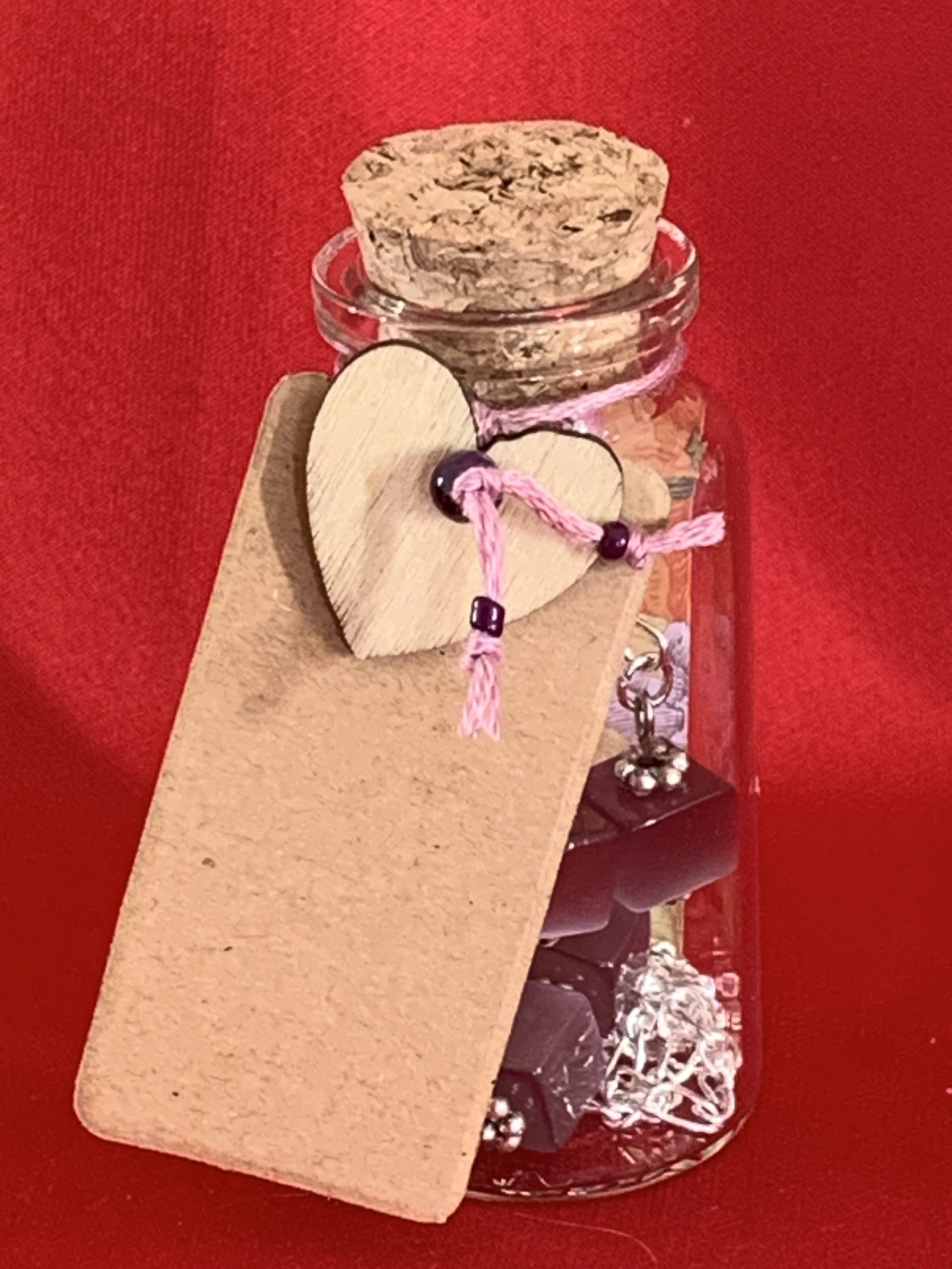 Sterling silver earrings and necklace set with purple squares inside a message in a bottle