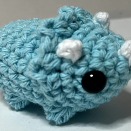 Small hand made crocheted dinosaur amigurumi keychain