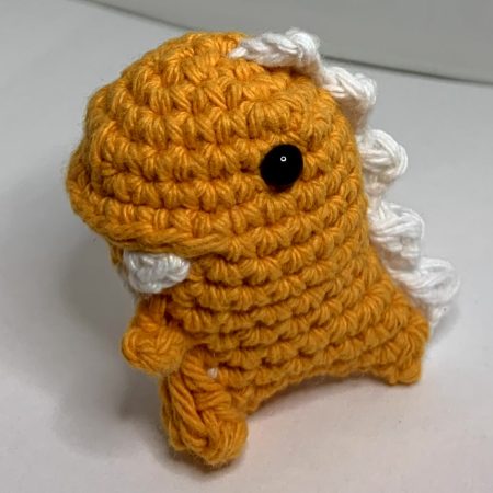 Small hand made crocheted dinosaur amigurumi keychain