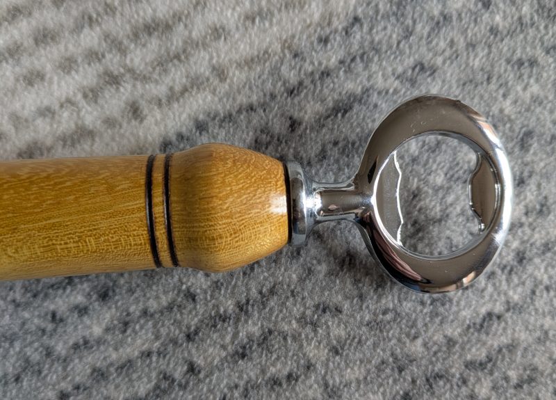 Handmade Iroko bottle opener with a stainless steel opener