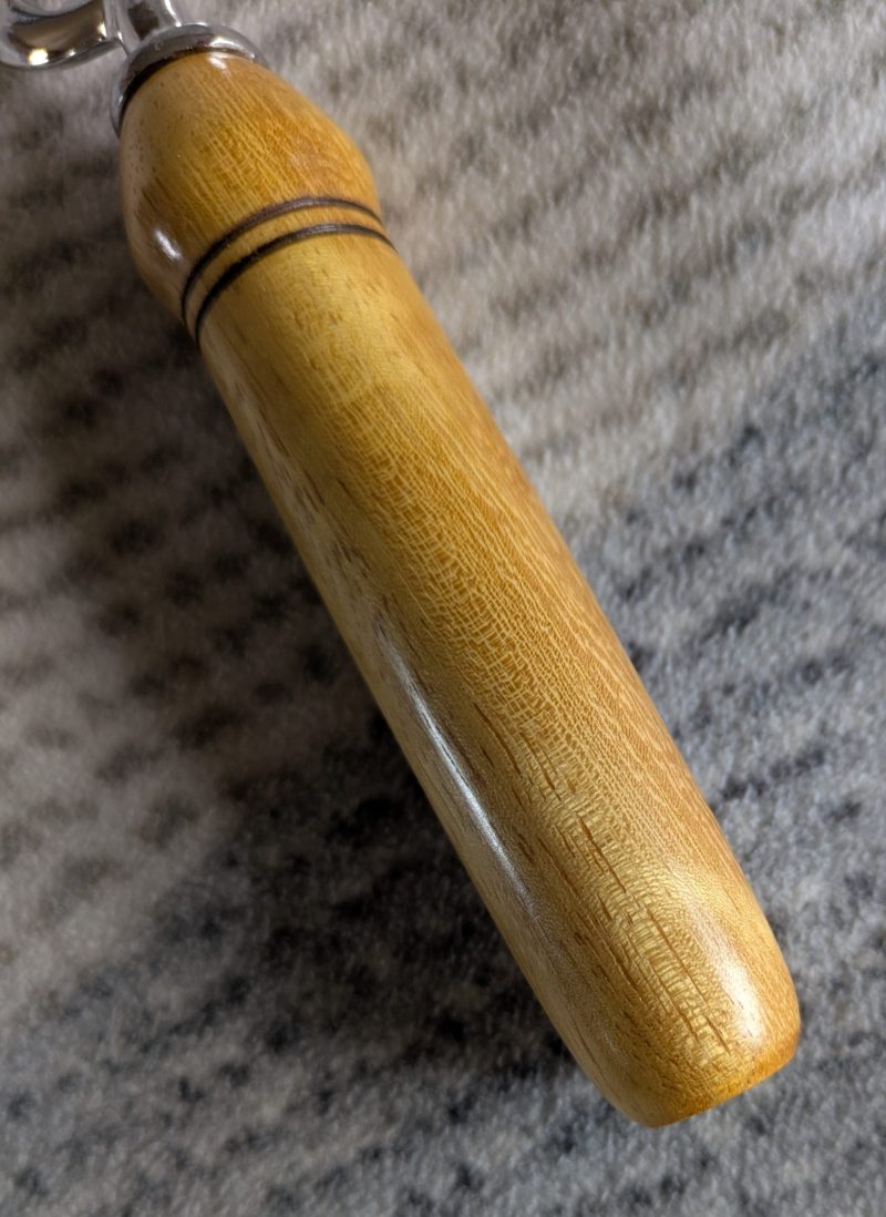 Handmade Iroko bottle opener with a stainless steel opener