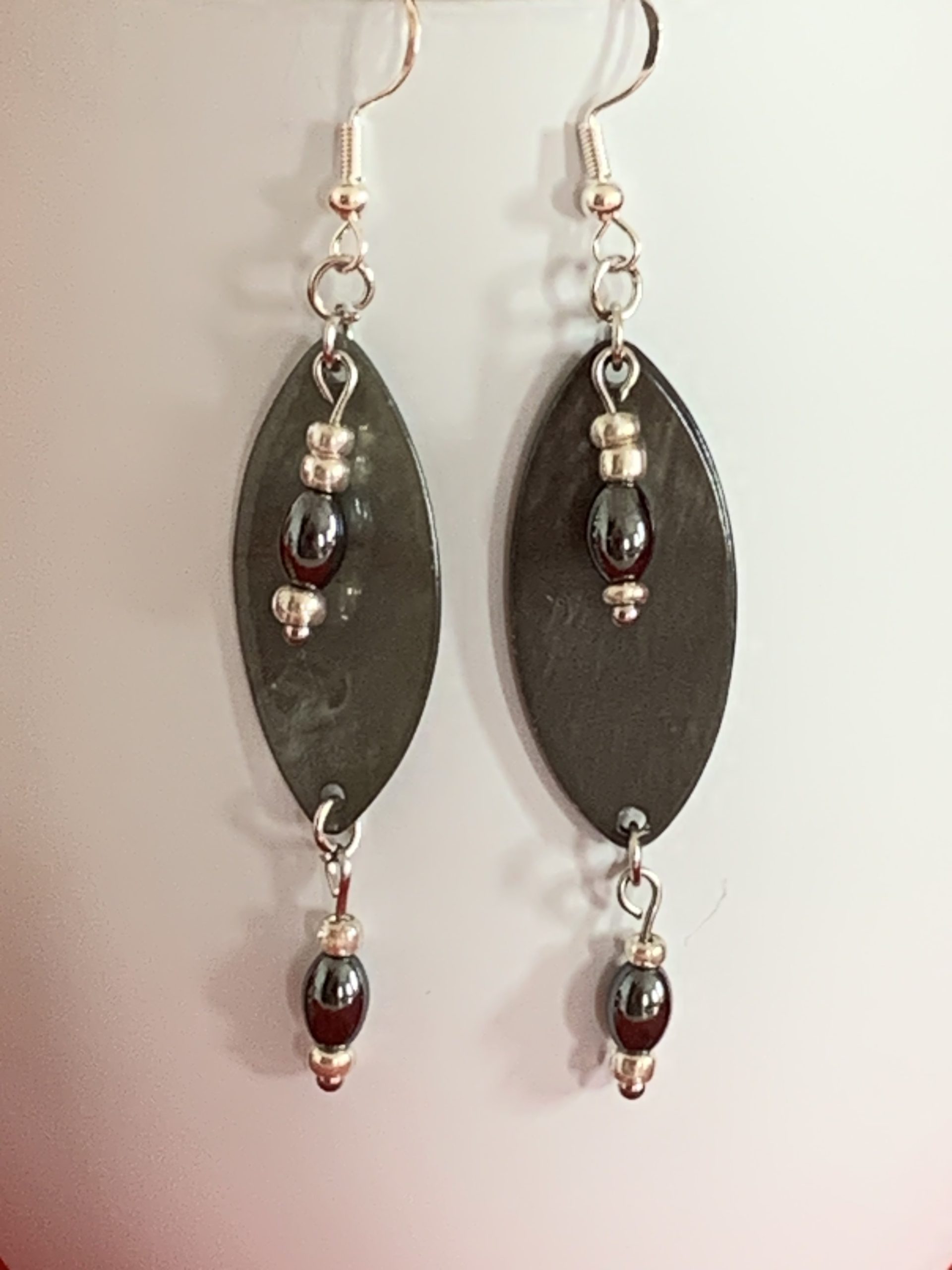Lovely handmade sterling silver earrings with Hematite coloured beads in a bottle with scroll