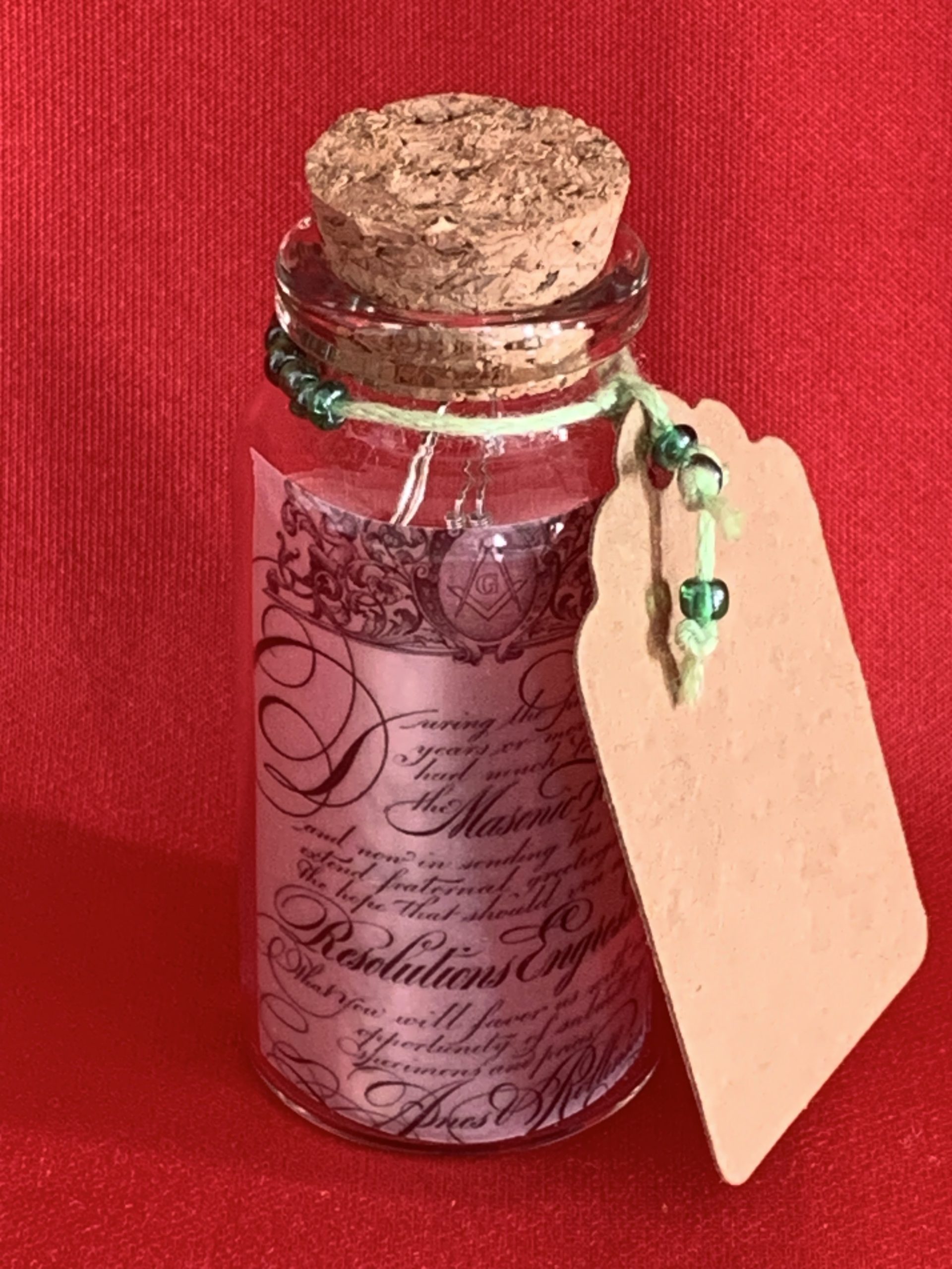 Lovely handmade sterling silver earrings with green stone hearts & beads in a bottle with scroll