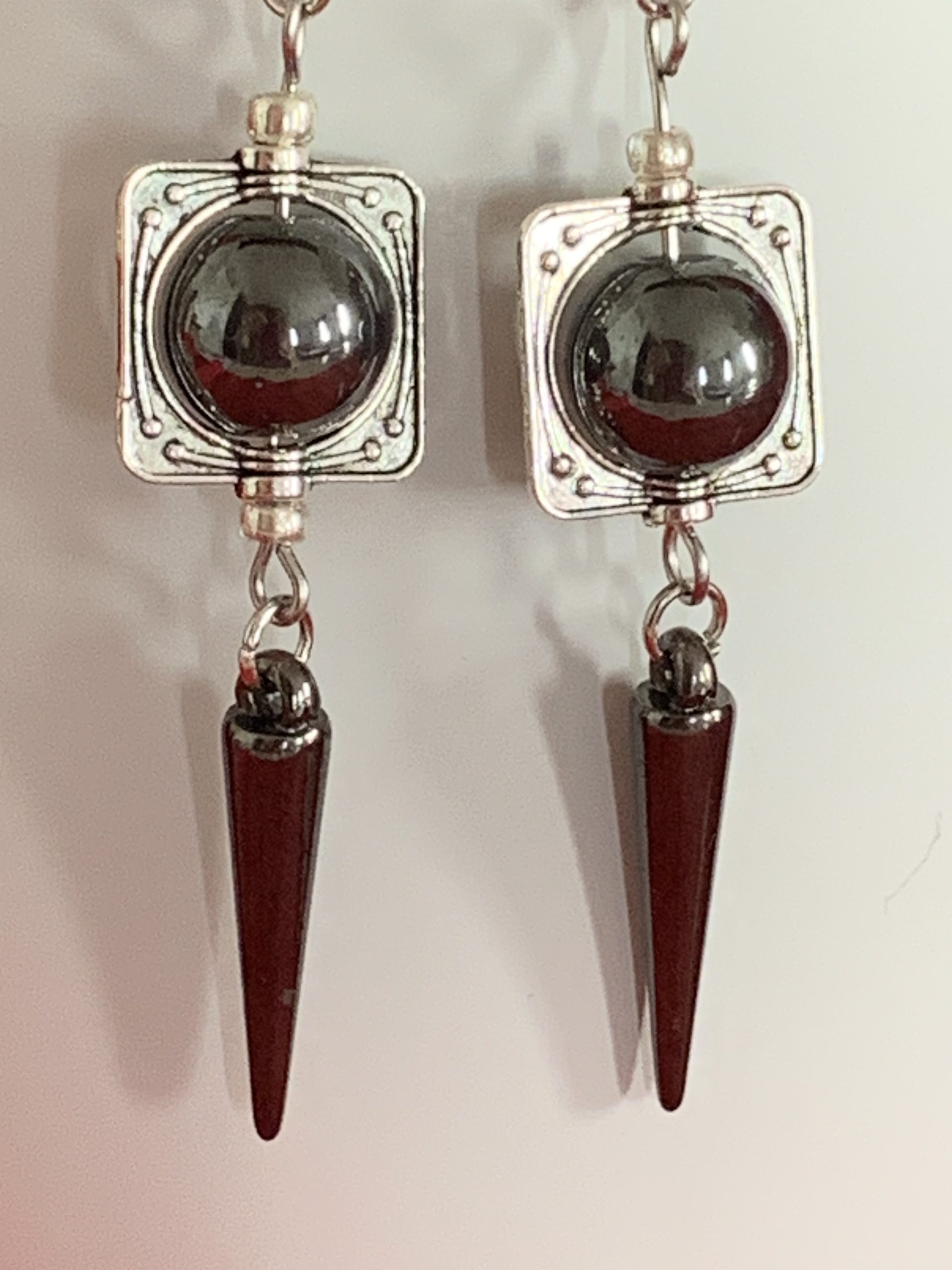 Lovely handmade sterling silver earrings with hematite coloured beads and spear drops in a bottle