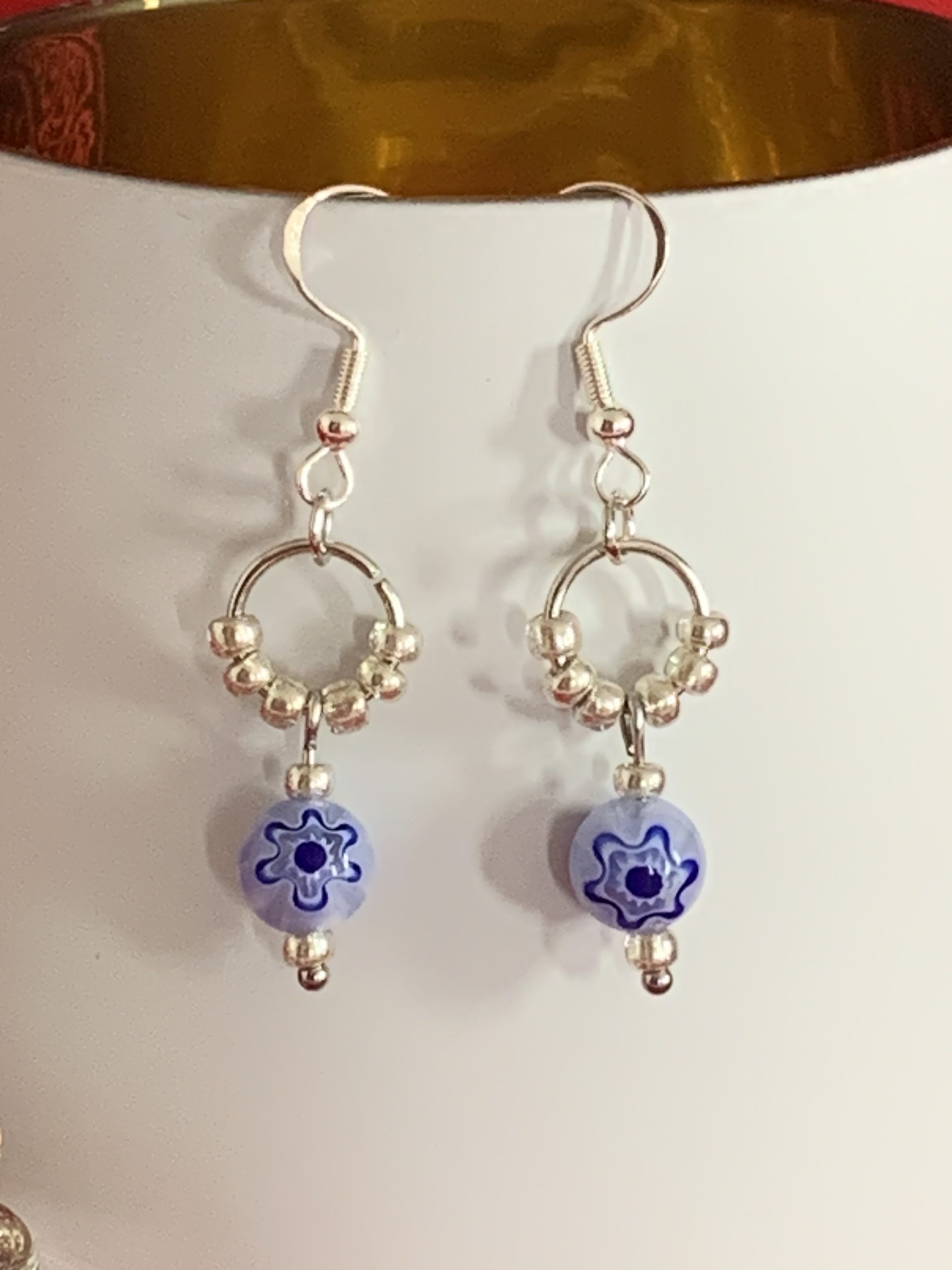 Lovely handmade sterling silver earrings with floral blue glass beads in a bottle with scroll