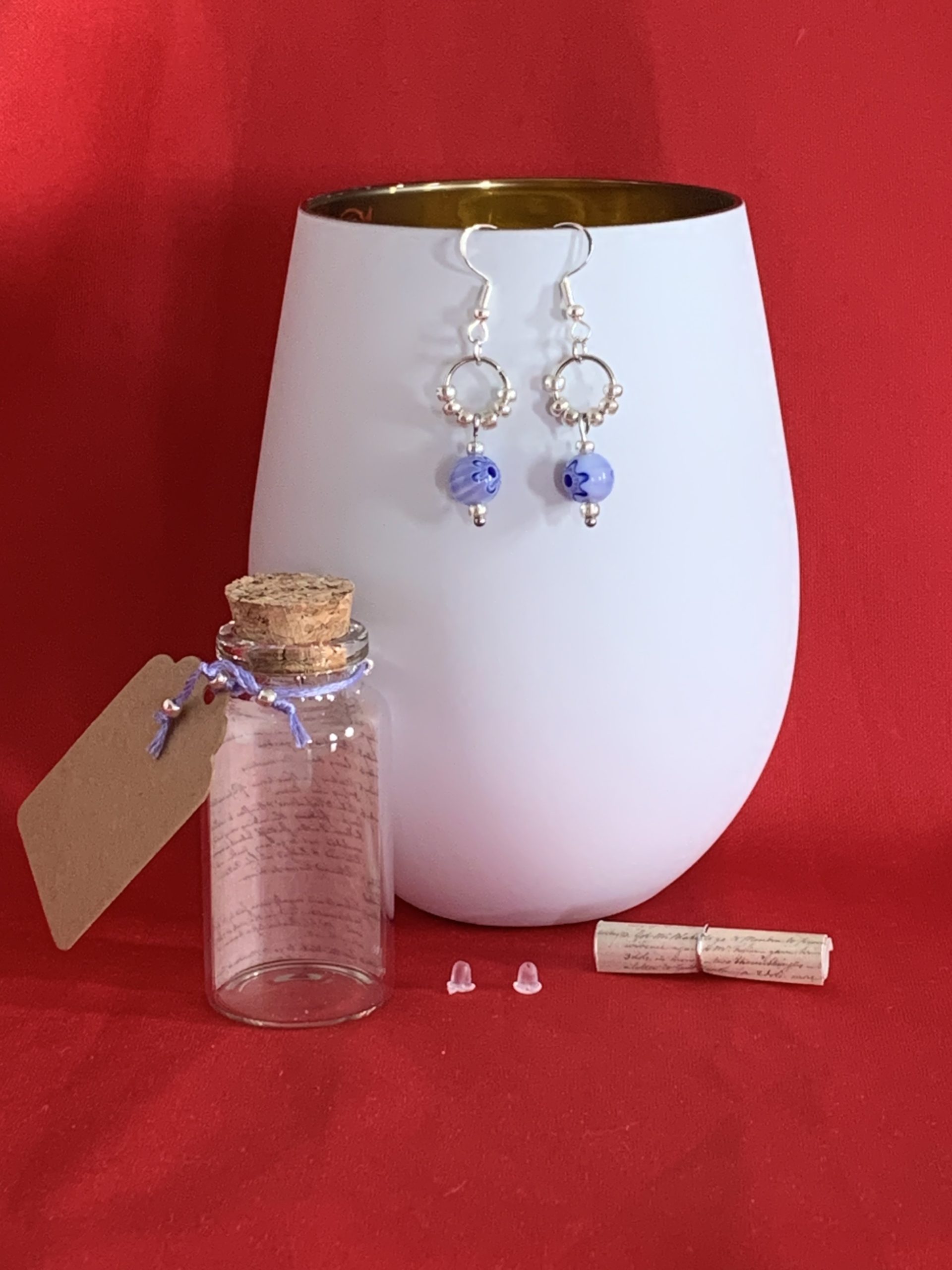 Lovely handmade sterling silver earrings with floral blue glass beads in a bottle with scroll