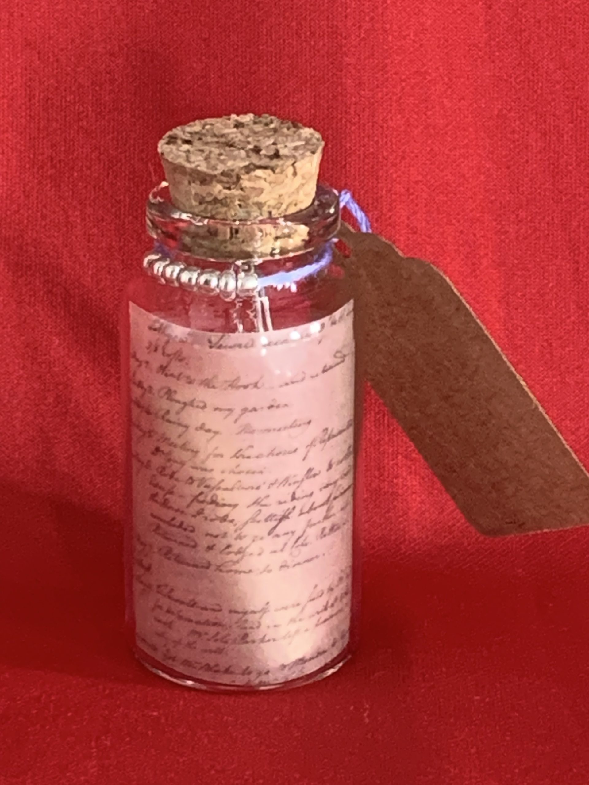 Lovely handmade sterling silver earrings with floral blue glass beads in a bottle with scroll