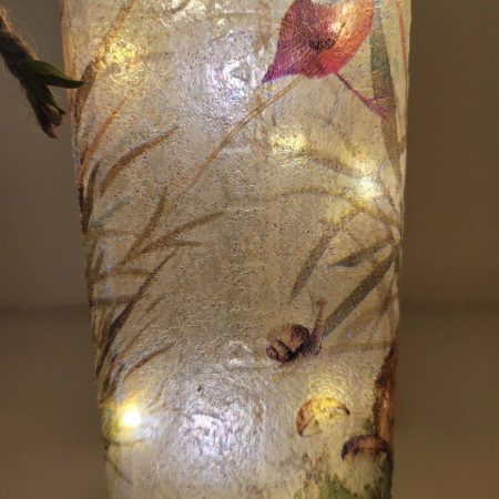Square gin bottle, lit up with grass and snail detailing