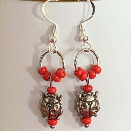 Lovely handmade sterling silver earrings with ladybirds & beads in a bottle with butterfly scroll