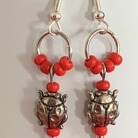 Lovely handmade sterling silver earrings with ladybirds & beads in a bottle with butterfly scroll