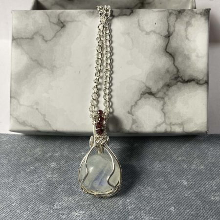 Wire-wrapped moonstone and garnet pendant