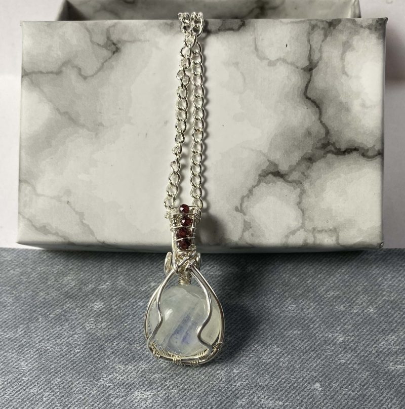 Wire-wrapped moonstone and garnet pendant