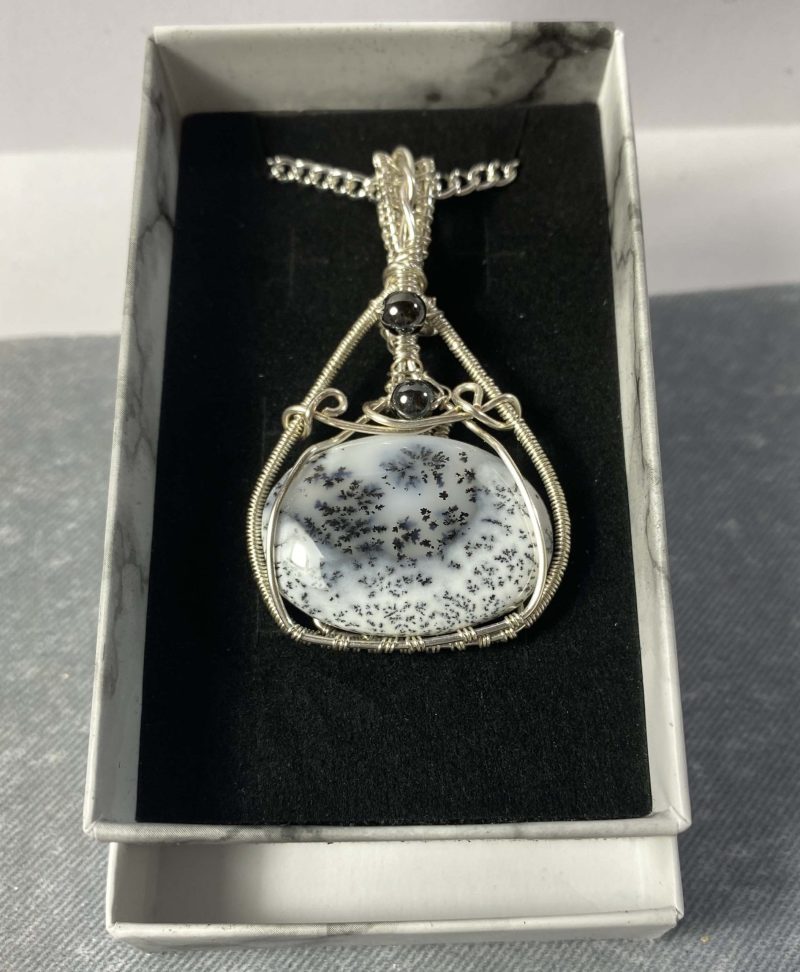 Absolutely stunning dendritic chalcedony wrapped in silver plated wire with haematite detail