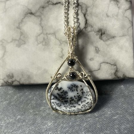 Absolutely stunning dendritic chalcedony wrapped in silver plated wire with haematite detail