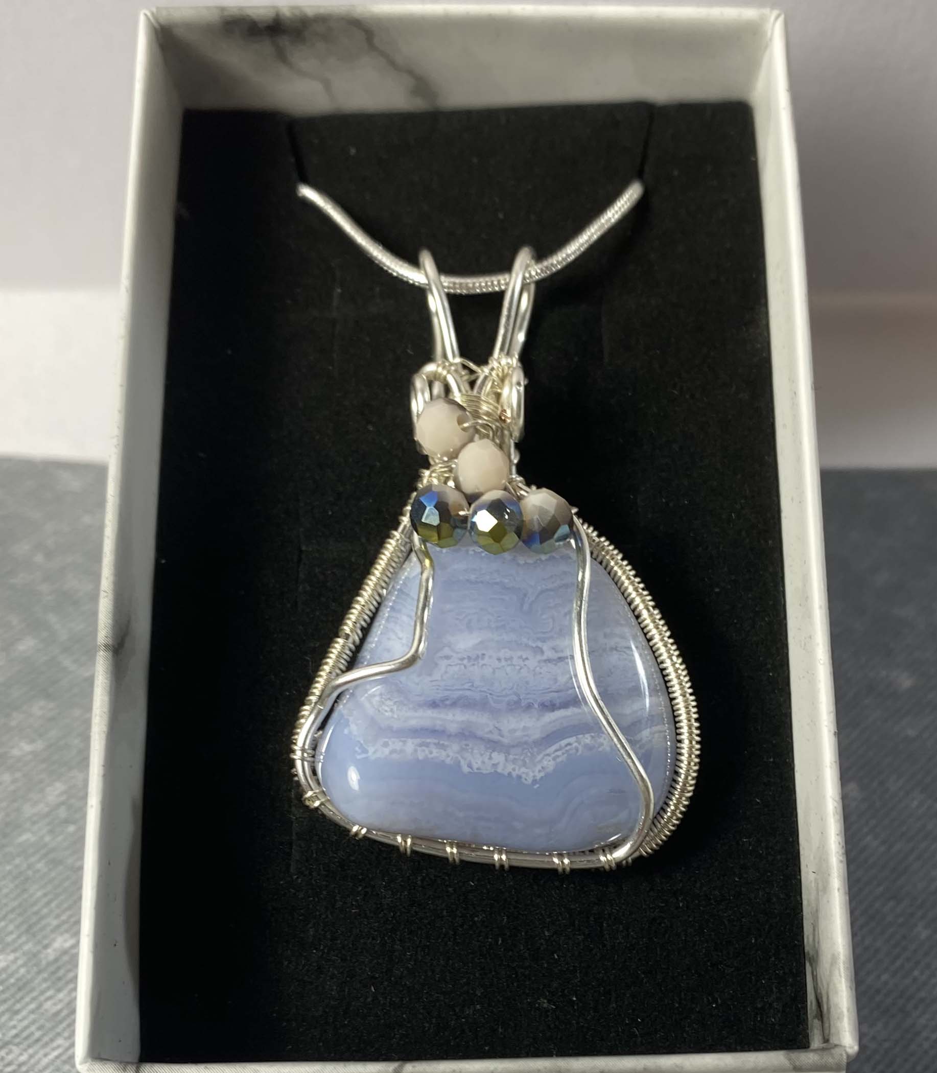 Beautiful blue lace agate wrapped in silver plated wire with bead detail