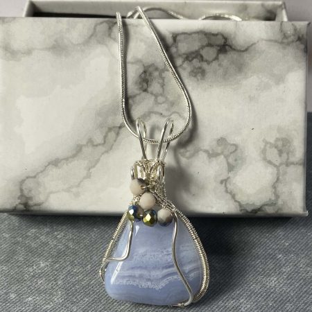 Beautiful blue lace agate wrapped in silver plated wire with bead detail