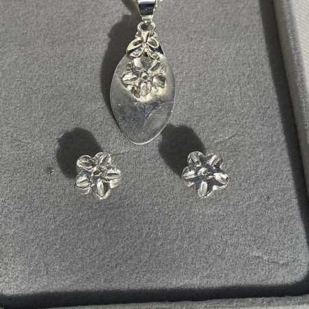 Pretty flower design pendant and earrings set in fine and sterling silver