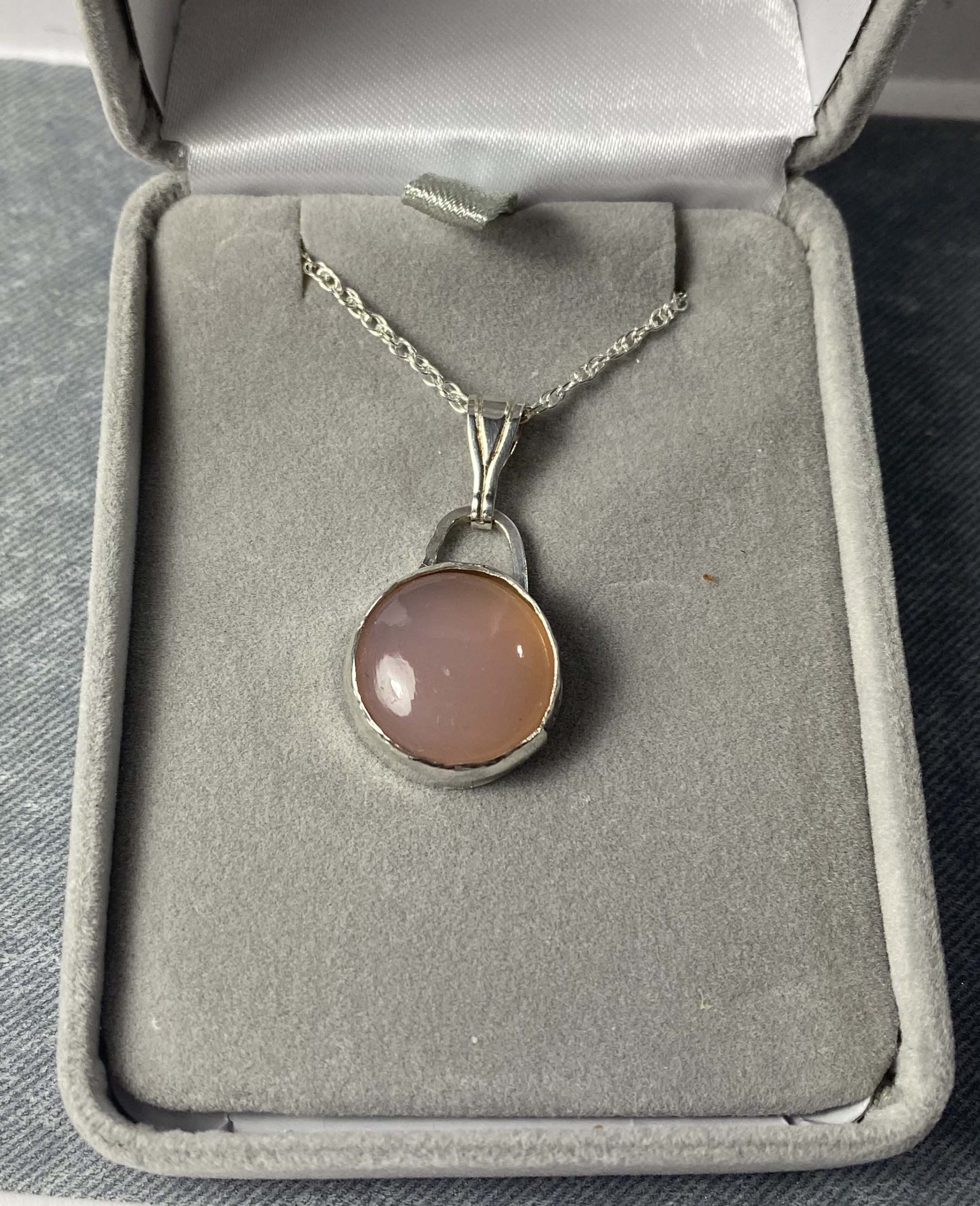 Elegant sterling silver pendant with pink chalcedony cabochon
