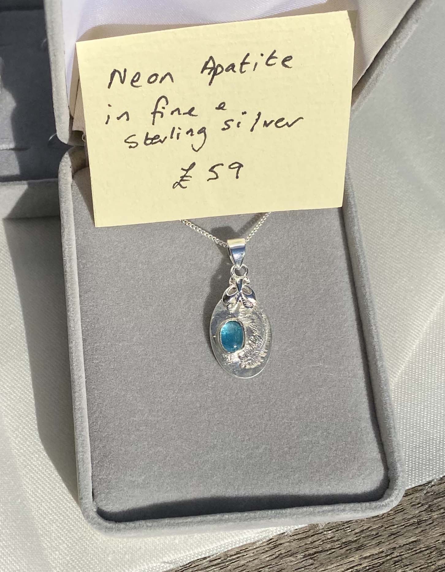 Delicate fine and sterling silver pendant set with neon apatite