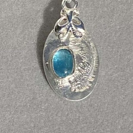 Delicate fine and sterling silver pendant set with neon apatite