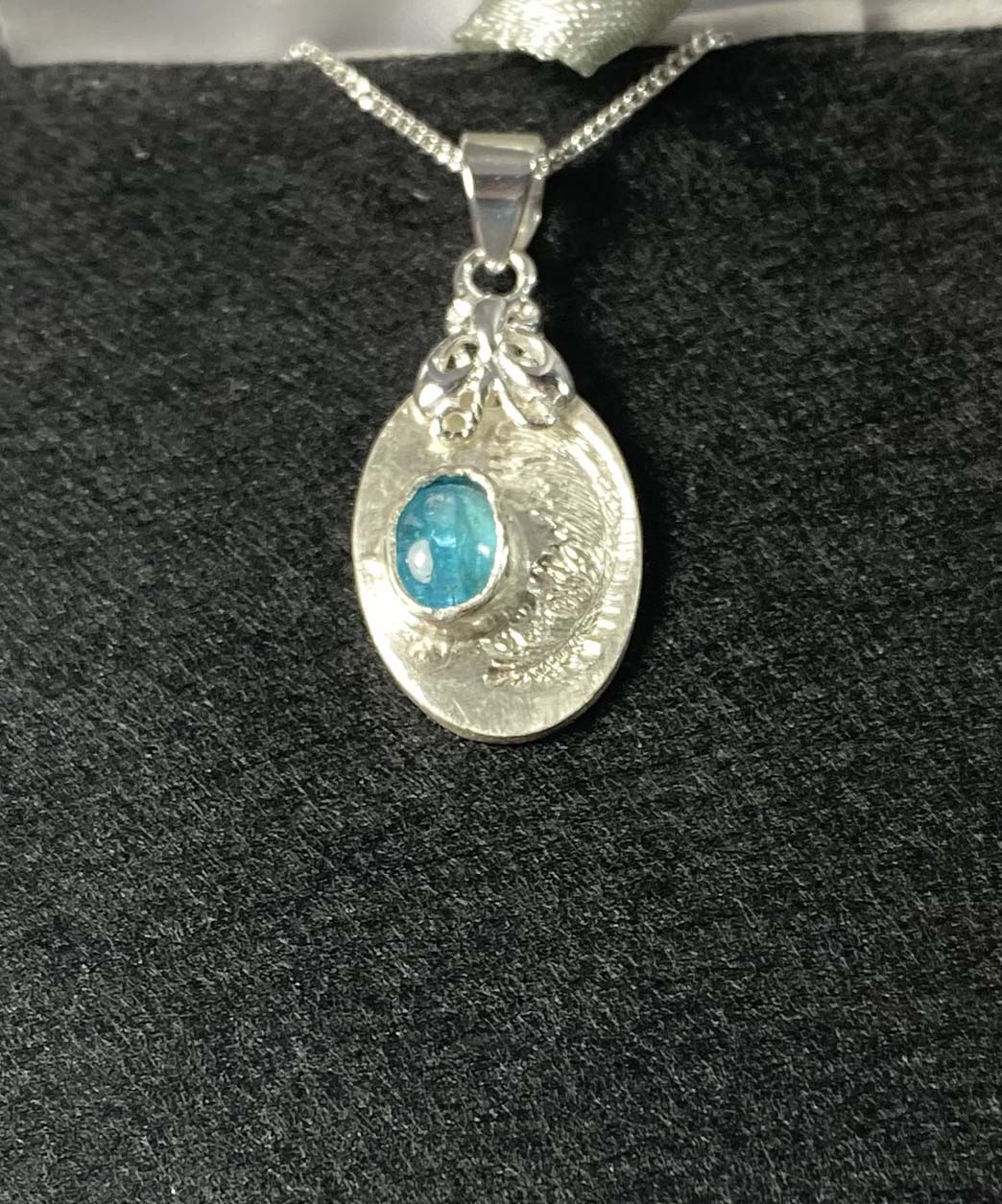 Delicate fine and sterling silver pendant set with neon apatite