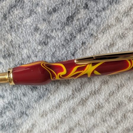 Seam ripper-unpicker made from red and yellow acrylic with gold coloured fittings