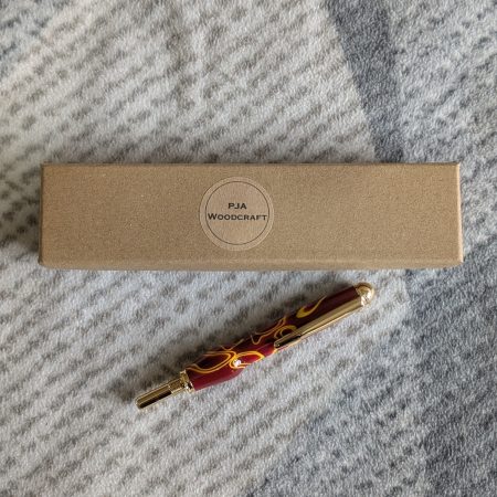 Seam ripper-unpicker made from red and yellow acrylic with gold coloured fittings