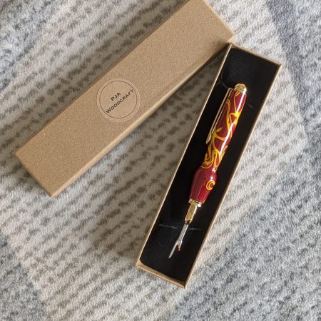 Seam ripper-unpicker made from red and yellow acrylic with gold coloured fittings