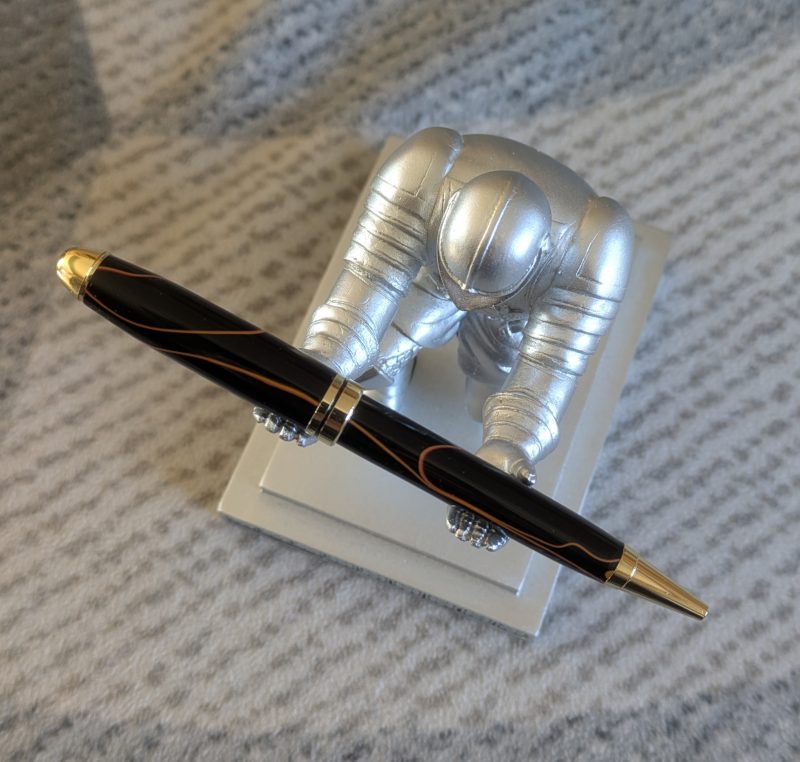 Euro twist acrylic ballpoint pen in black with burnt orange coloured lines