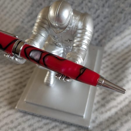 Euro twist ballpoint pen in red acrylic with black lines and swirls with shiny chrome fittings
