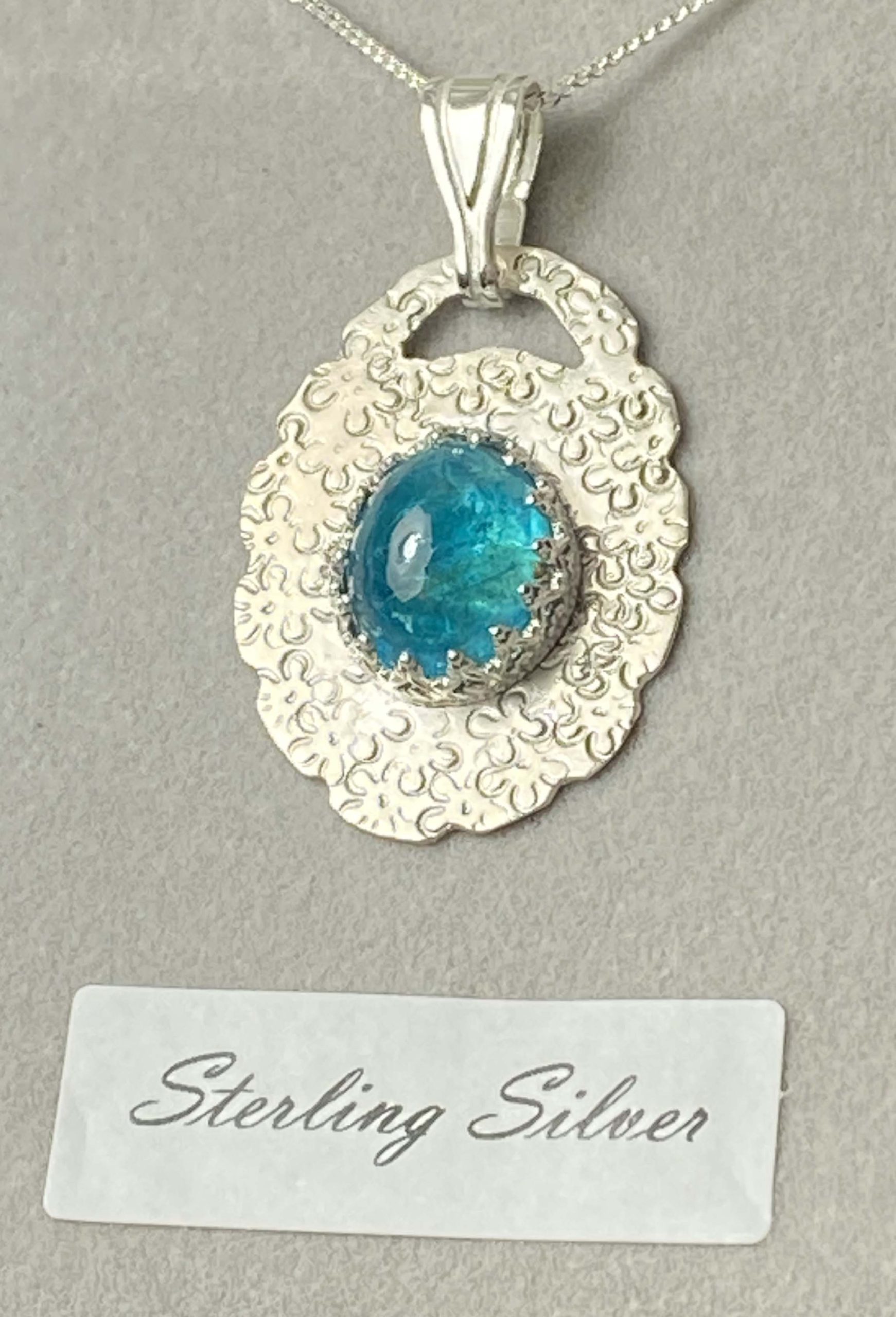 Stunning sterling silver pendant set with beautiful neon apatite