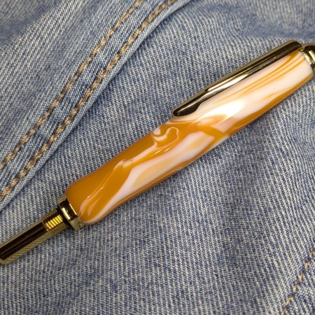 Seam ripper-unpicker made from caramel and cream coloured acrylic with shiny gold coloured fittings