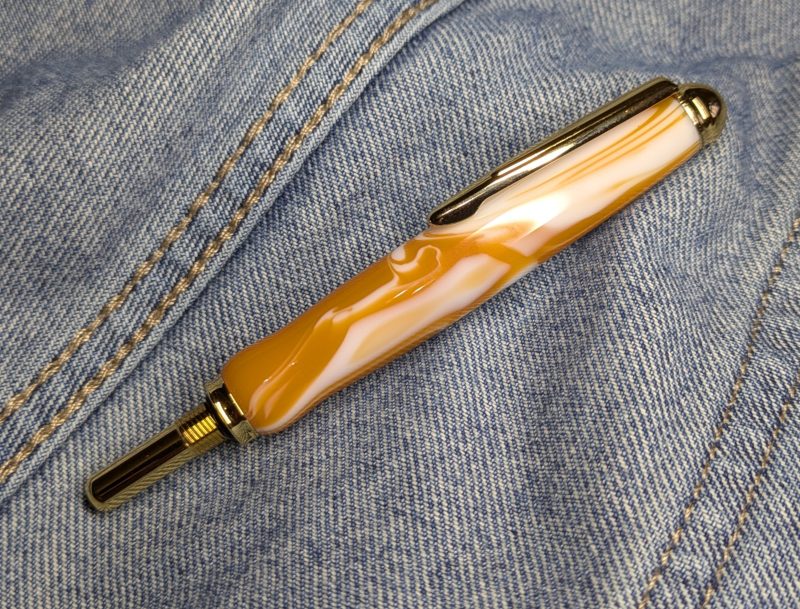 Seam ripper-unpicker made from caramel and cream coloured acrylic with shiny gold coloured fittings