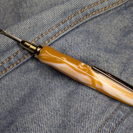 Seam ripper-unpicker made from caramel and cream coloured acrylic with shiny gold coloured fittings