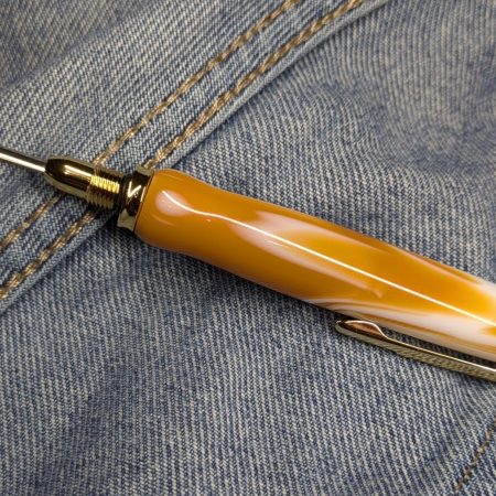 Seam ripper-unpicker made from caramel and cream coloured acrylic with shiny gold coloured fittings