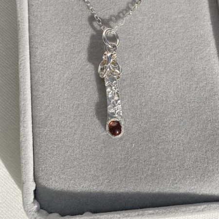 Delicate, elegant fine and sterling silver pendant set with rhodonite garnet