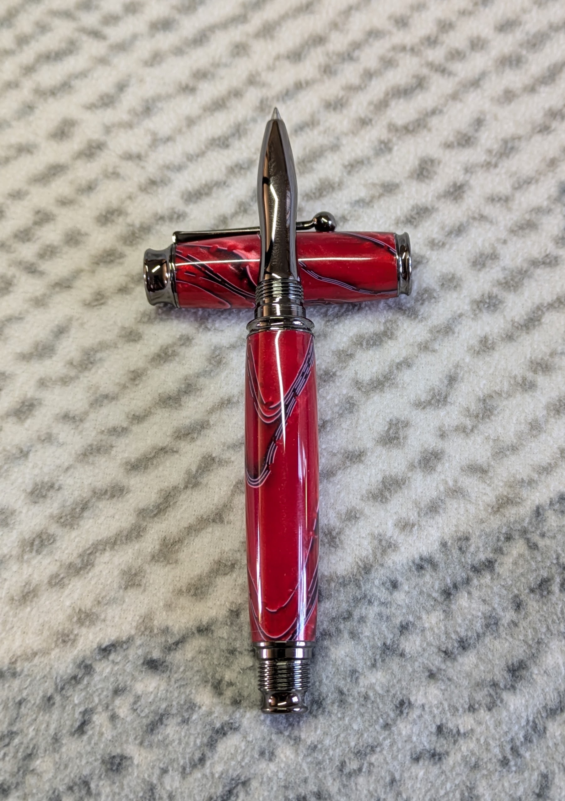 Acrylic omega style Rollerball Pen Made from red acrylic; with black and white lines
