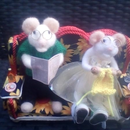 Needle felted couple on lovely orange and black settee