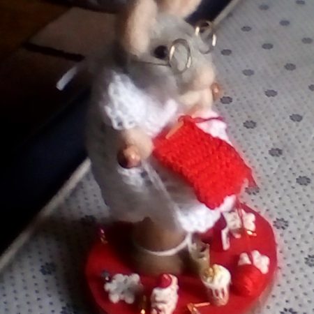 debby mouse busy knitting while surrounded with her little treats