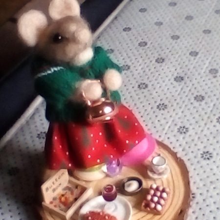 needle felted spool mouse getting ready for her lunch