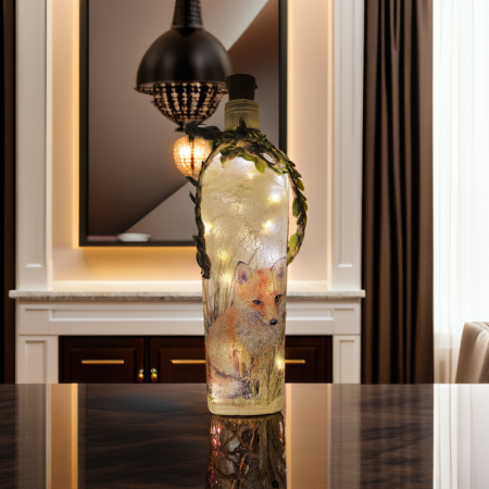 square gin bottle with fox detail. cork led lights and jute twine string with leaves tied around the neck of the bottle
