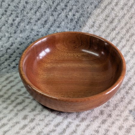 Small wooden bowl made from mahogany with a gloss finish