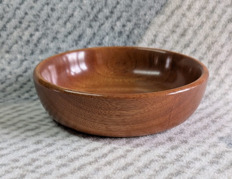 Small wooden bowl made from mahogany with a gloss finish