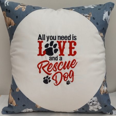 Hand made embroidered cushion with "All you need is Love and a Rescue Dog".